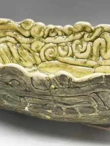 Inspired by the ancient wetlands and hidden waterways of Kauaʻi, this sculptural vessel reflects the feeling of entering a living forest where roots, stones, and water intertwine. (view 3 of 4)