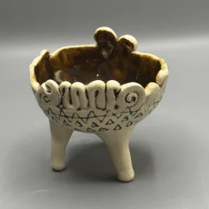 Speaks to the quiet rituals that help us remain whole — raised on long legs like a ceremonial vessel, part offering bowl, part guardian figure.