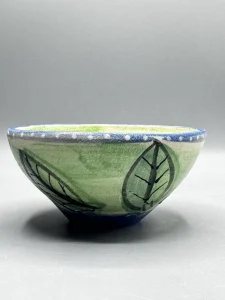The soft green interior and deep cobalt rim give this piece a calm, reflective presence. (view 2 of 4)