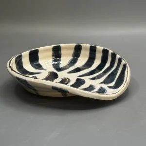 Explores movement beneath stillness — flowing black markings like tides or repeating emotional patterns.