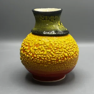 A layered surface caught between eruption and stillness — glowing yellows and volcanic tones suggest emotional heat carried beneath the surface.