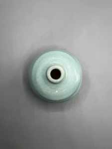 A quiet bottle form shaped around softness, rhythm, and containment. (view 3 of 4)