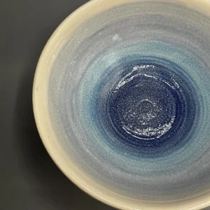 Soft bands of blue move across the surface like distant tide lines or remembered horizons. (view 3 of 4)